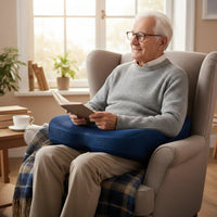 personne agé assis avec un coussin ergonomique sur les genoux