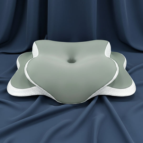 Coussin ergonomique anti-ronflement Ergomax 2 gris-vert en mousse à mémoire de forme sur un tissu bleu foncé.