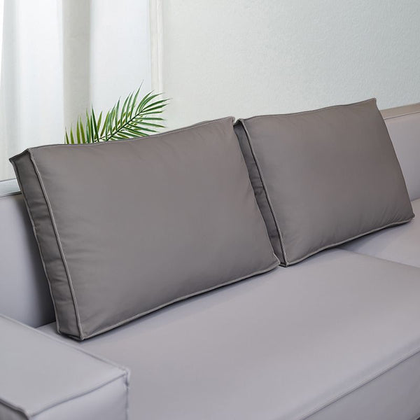 Coussin dossier canapé gris rectangulaire en simili cuir pour canapé sur un canapé avec un mur blanc