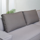 Coussin dossier canapé gris rectangulaire en simili cuir pour canapé sur un canapé avec un mur blanc