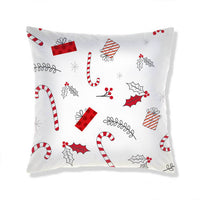 Coussin de Noël festif avec motifs de cannes à sucre, cadeaux et houx sur fond blanc