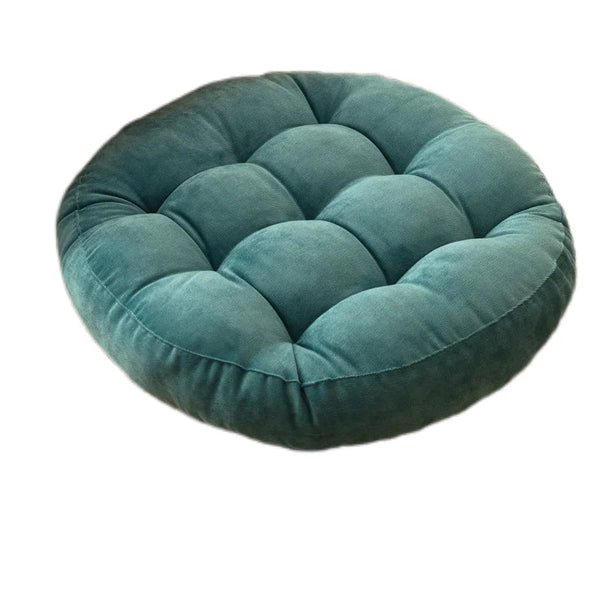 Coussin de sol capitonné rond turquoise sur fond blanc