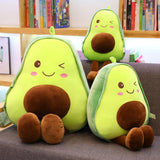 Coussin peluche en forme d'avocat mignon qye fqit un sourire et un clin d'oeuil. Les trois avocats sont assis dans en un canapé