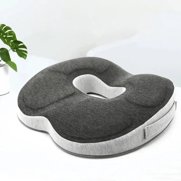 Coussin coccyx ergonomique d'assise bicolore, gris clair et gris foncé sur un fond blanc